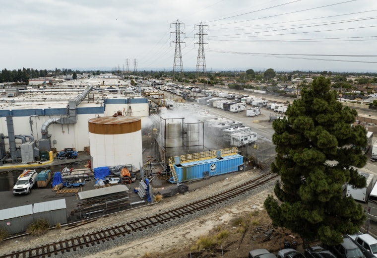 A drone photo of an industrial yard surrounded by train tracks.