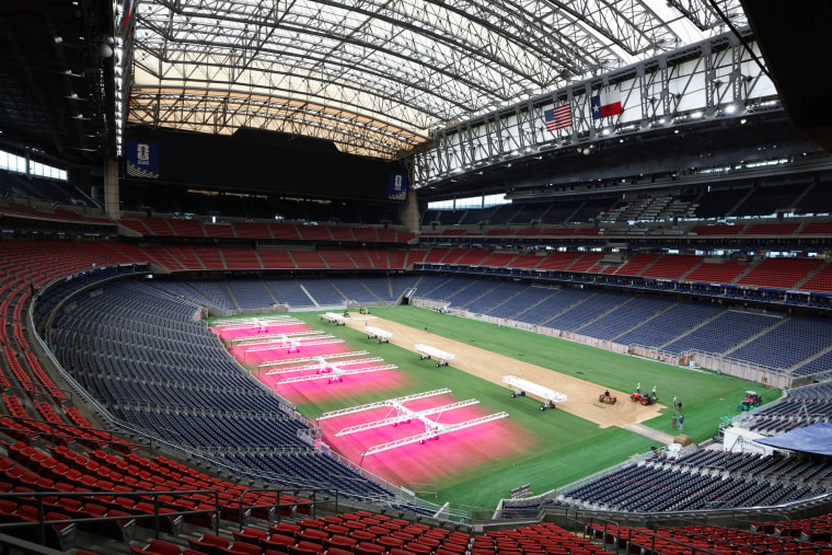 An interior view of NRG Stadium, the astroturf is being sprayed with a pink substance